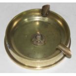 A trench art brass shell case ashtray with Royal Army Ordance Corps badge, diam.13cm.