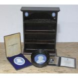 Two Wedgwood Jasperware plaques and a collectors stand.