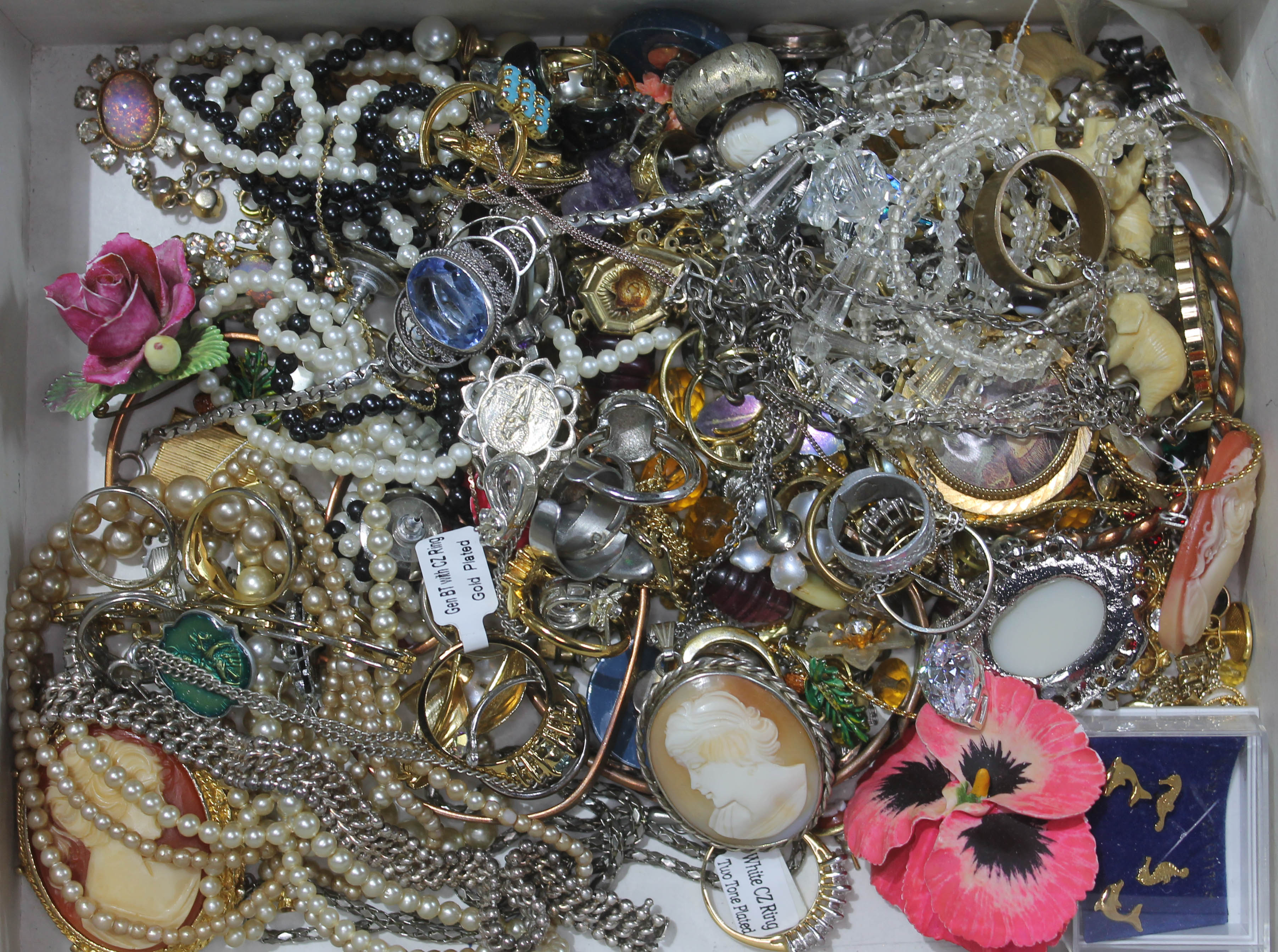 A box of costume jewellery including a cameo pendant, rings etc.