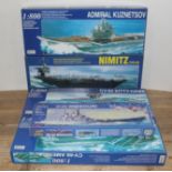 Five boxed motor driven battleship models comprising 1:800 scale CV-63 Kitty-Hawk, CV-66 America,