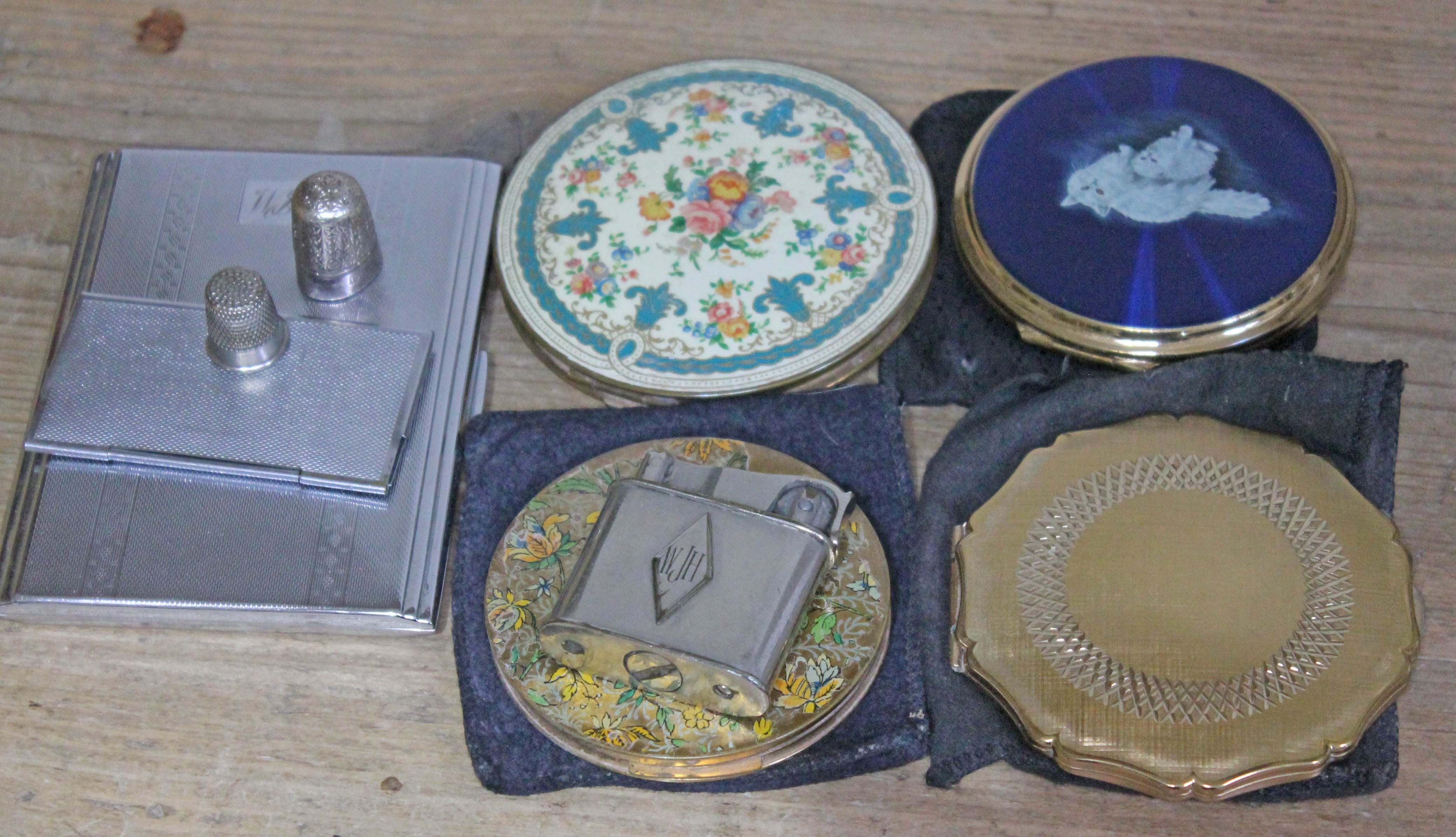 A mixed lot comprising four vintage compacts, a lighter, a cigarette case, a stamp case and a
