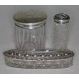 Three cut glass dressing table pots/jars with hallmarked silver tops.