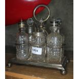 A silver plated cruet stand with six cut glass cruets having silver plated tops, height approx 22cm,