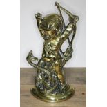 An early 19th century lead weight brass door stop formed as cupid fighting a serpent, number 8310,