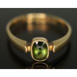 An Edwardian 18ct gold ring set with an oval cut peridot, gross wt. 2.47g, size N/O. Condition -