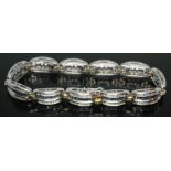 A contemporary diamond and sapphire bracelet, total approx. diamond wt. 1.98ct, each segment