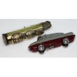 A trench art lighter and another formed as a car.