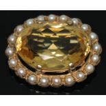 A hallmarked 9ct gold citrine and cultured pearl brooch, the oval mixed cut citrine weighing approx.