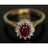A diamond and ruby cluster ring, the cluster measuring approx. 9mm x 7mm, hallmarked 18ct gold,