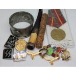 A mixed lot including an Arts & Crafts pewter serviette ring, a cheroot holder, a carved needle