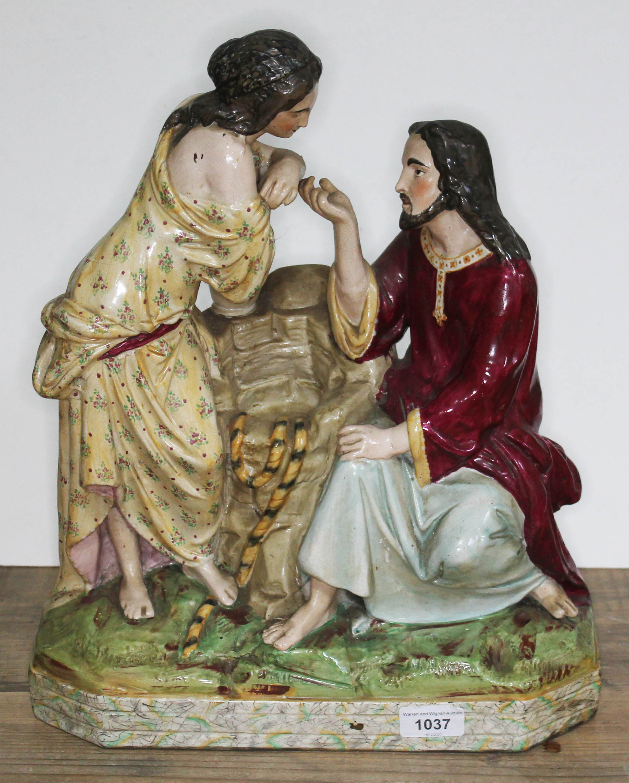 A large 19th century pottery figure group after Carrier Belleuse depicting a courting couple by a