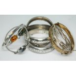 A quantity of bangles comprising two hallmarked Scottish silver; one set with moss agate and the