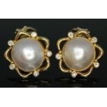 A pair of Mikimoto style 18ct gold mabe pearl and diamond earrings, each central blister pearl