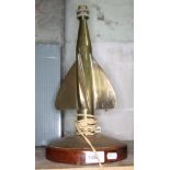 A brass table lamp formed as a propeller on round wooden base, height to top of bulb fitting 38cm.