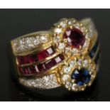 A diamond, ruby and sapphire cluster ring, marked '14k', gross wt. 7.70g, size M.