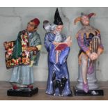 Three large Royal Doulton figures - The Jester HN2016; Carpet Seller HN1464; The Wizard HN2877 All