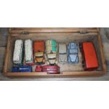 A wooden box with seven playworn Dinky model vehicles, one Timpo Toys and a Tri Ang Minic Toys