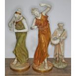Three Royal Worcester blush ivory porcelain figures comprising two musicians and a water carrier,
