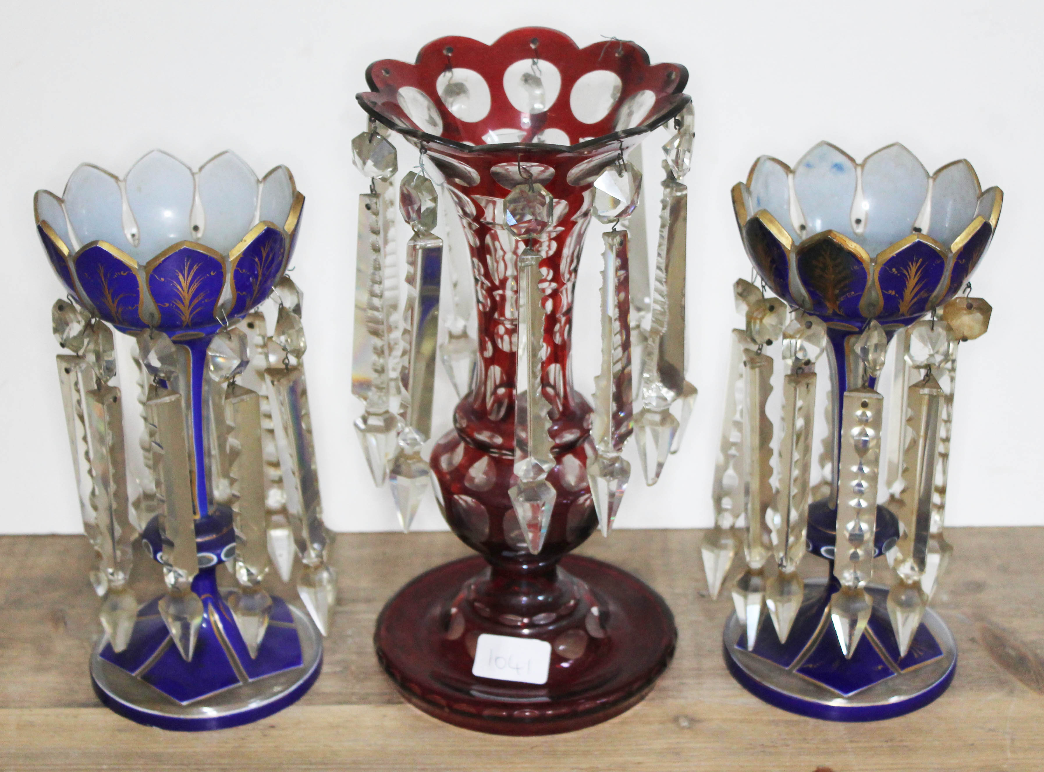 A pair of blue glass bohemian drop lustre vases together with another single red glass drop lustre