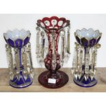 A pair of blue glass bohemian drop lustre vases together with another single red glass drop lustre