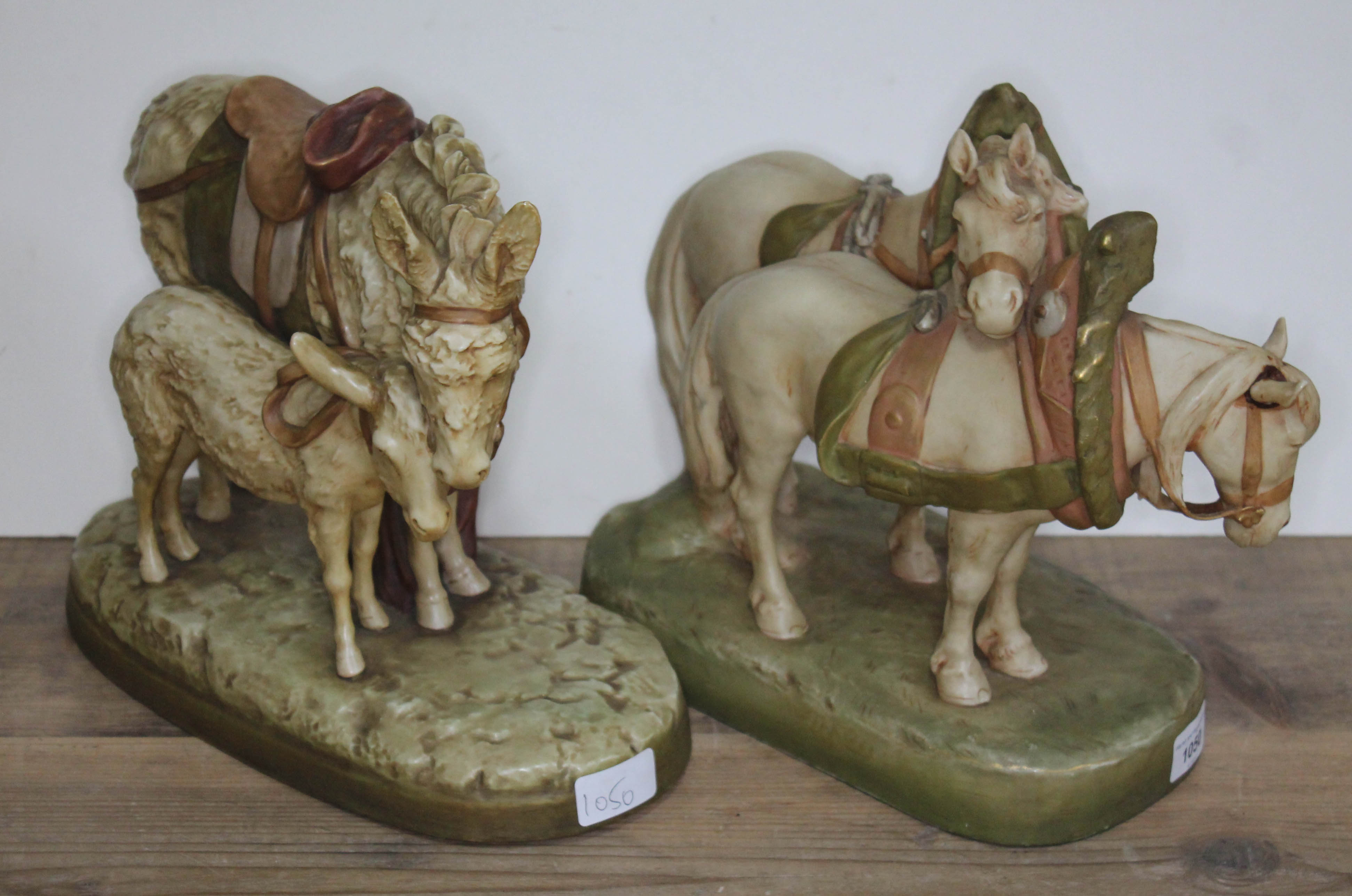 A Royal Dux figure of two horses with bridles & reins together with a figure of donkey and foal,