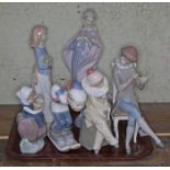 A collection of 6 Lladro figures. Girl skiing; girl with plant pot; girl in clown suit with book;