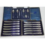Two cased sets of hallmarked silver handled knives and a cased set of hallmarked silver teaspoons