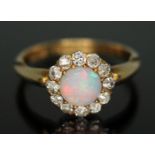 A late Victorian diamond and opal ring, the central precious opal diam. approx. 5.87mm and depth 2.