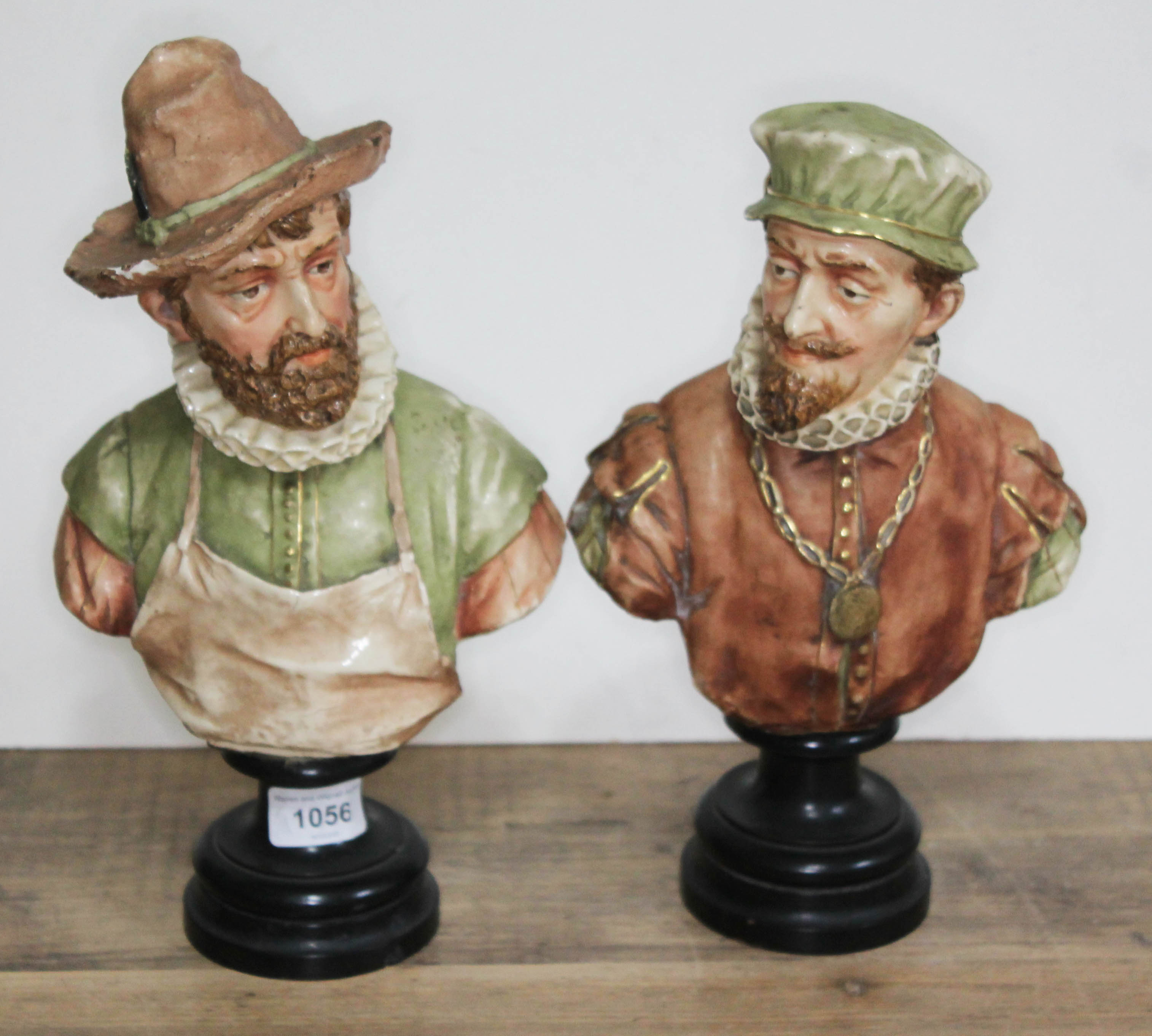 A pair of 19th century Goldscheider busts of men in Elizabethan dress on stands, model numbers 316 &