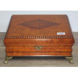 A satinwood work box with gadrooned edge, brass paw feet, and fitted interior, height 15cm length