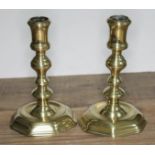 A pair brass candlesticks, heights 17cm. Condition: dents to both sticks.