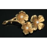 A hallmarked 9ct gold spray brooch set with three cultured pearls, length 53mm, gross wt. 7.19g.