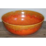 A Pilkingtons Royal Lancastrian mottled orange bowl, diam. 28cm. There are a number of small chips
