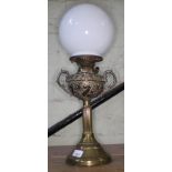 An embossed brass twin handled oil lamp, The New Rochester Jr with decorated bowl and milk glass