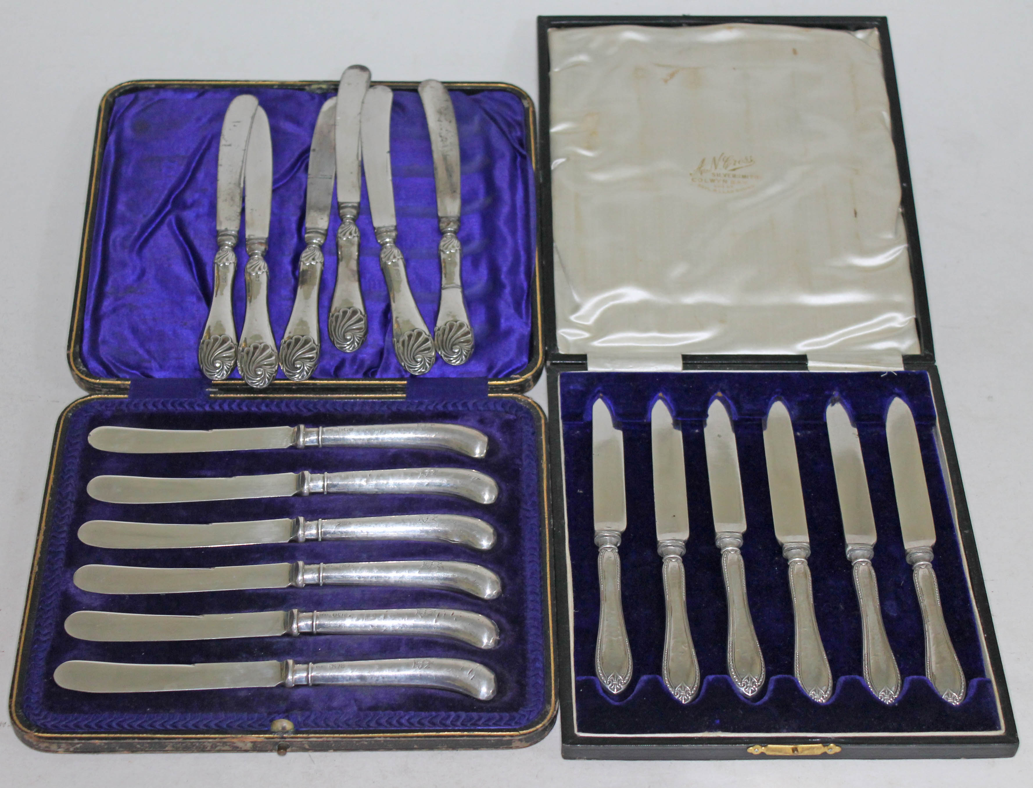 Two cased sets of hallmarked silver knives and another set.