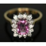 A diamond and synthetic pink sapphire/ruby cluster ring, the central vivid pink stone weighing