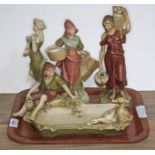 A group of four Royal Dux figures comprising water & food carriers, a musician and a dish with boy