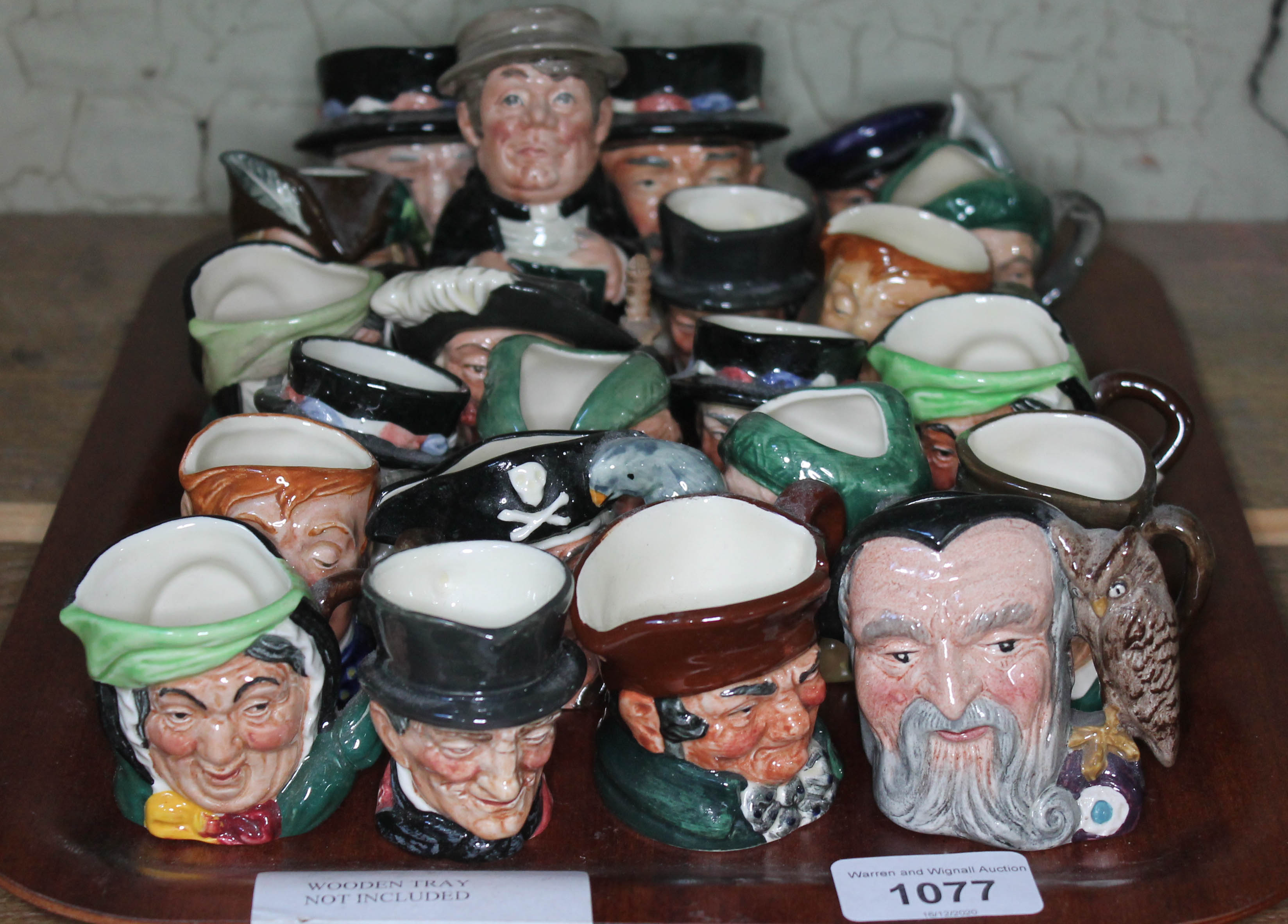 A collection of approx 22 small Royal Doulton character jugs including Merlin, Auld Mac, Sairey