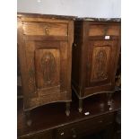 A pair of Continental oak bedside cabinets with carved floral panels and marble tops. Catalogue