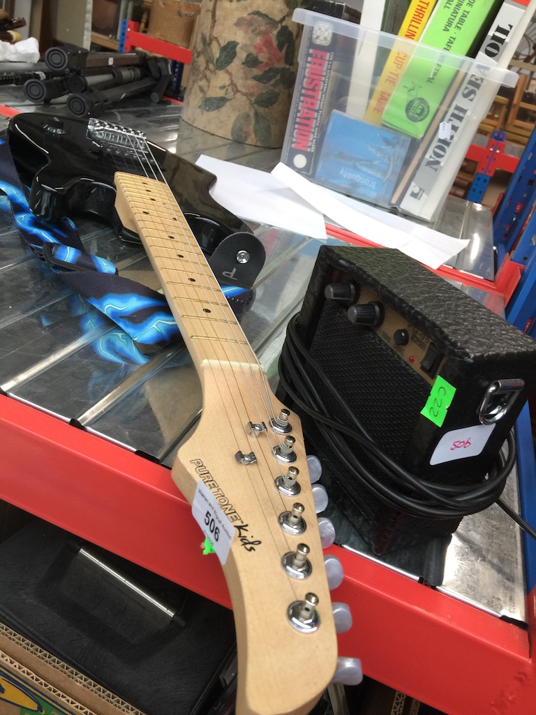A Pure Tone electric guitar for kids and a small PG-05 amp. Catalogue only, live bidding available