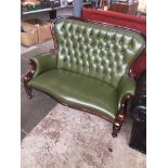 A reproduction green buttoned leather and wood show high back settee Catalogue only, live bidding