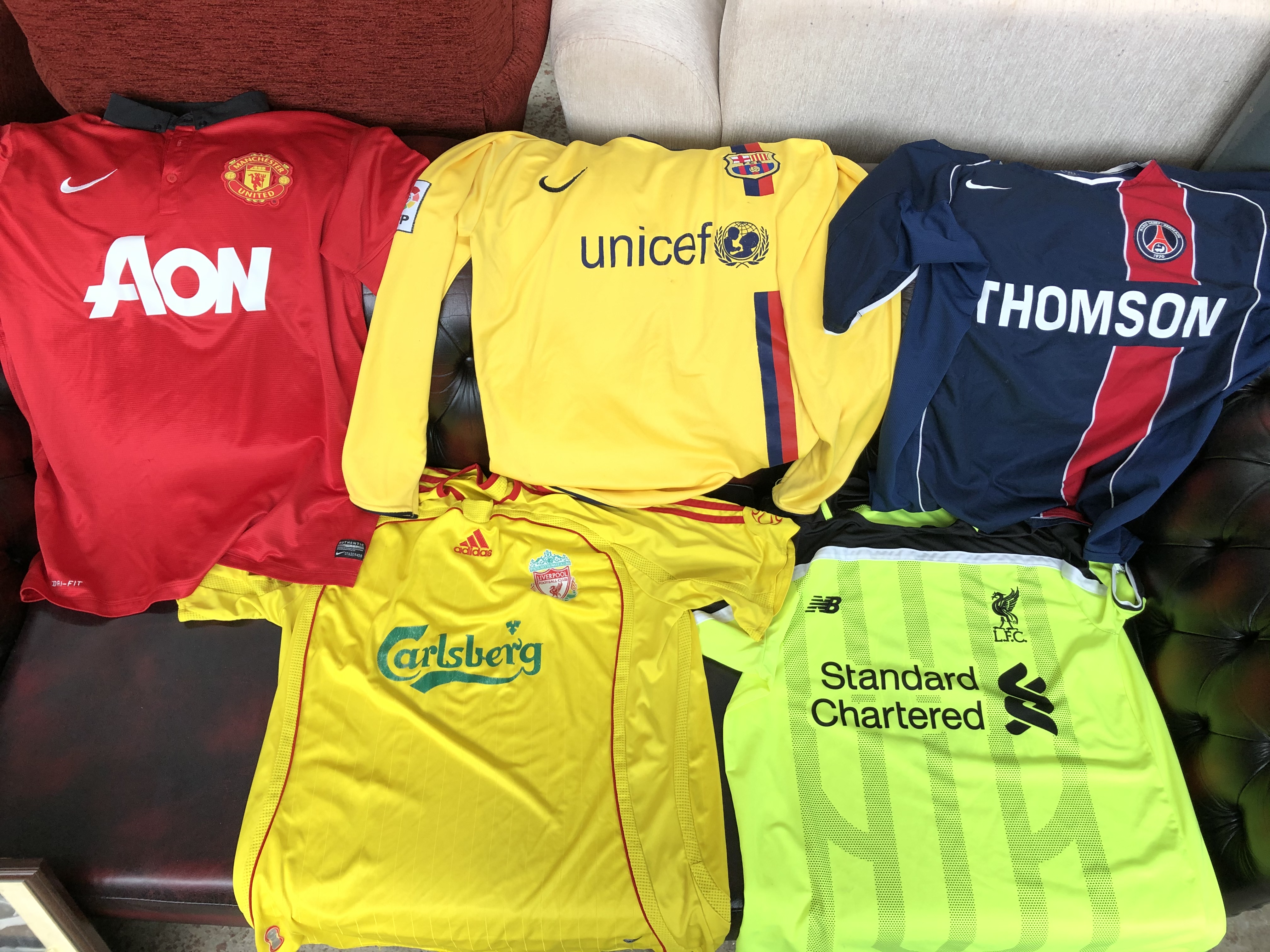 Collection of vintage football tops to include Liverpool, Man United, Arsenal, Barcelona, etc.