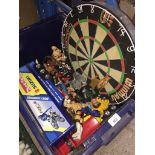A dart board and box of action and wrestling figures Catalogue only, live bidding available via