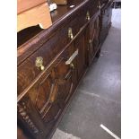 An oak sideboard with rail back, brass tear drop handles and geometric door panels Catalogue only,