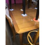 A mid 20th century teak extending dining table and four chairs Catalogue only, live bidding