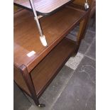A retro teak two tier trolley Catalogue only, live bidding available via our webiste. If you require