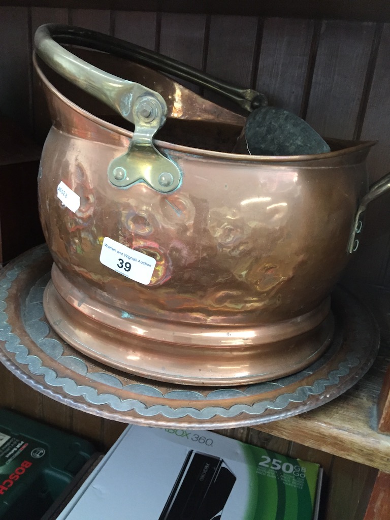 A copper coal bucket, copper charger, a small copper bowl and a copper and brass jug. Catalogue