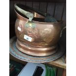 A copper coal bucket, copper charger, a small copper bowl and a copper and brass jug. Catalogue