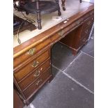 A large Hamptons of Kensington pedestal writing desk with burr walnut drawer fronts, brass handles
