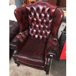 An oxblood leather Chesterfield wing back armchair Catalogue only, live bidding available via our
